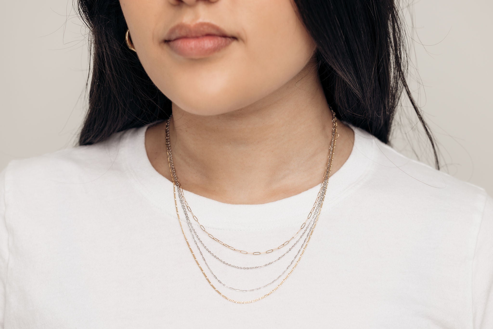 14k-gold-chain-necklace-stack-on-woman-3_923a4106-ee8f-4fed-afcb-ec104e143387.jpg