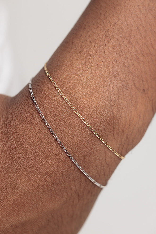 white gold and yellow gold figaro style bracelets